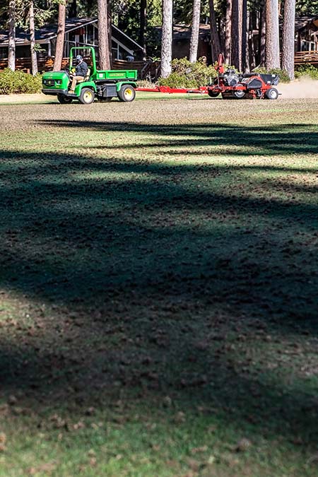 maintenance vehicle aerates the incline village championship golf course