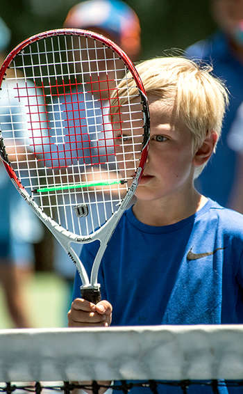 boy with racket at incline village tennis center youth camp