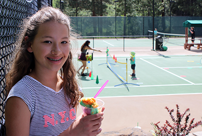 girl holding ice cream at tennis center social
