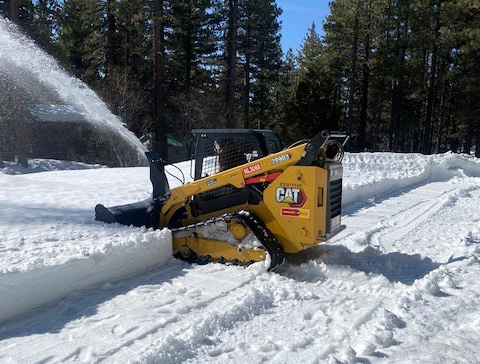 machine removes snow from golf course