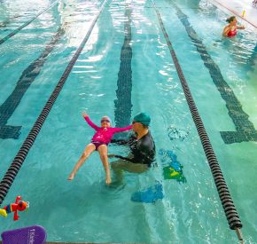 youth swim lesson girl in pool with instructor