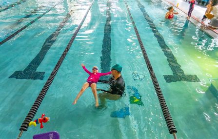 youth swim lesson girl in pool with instructor
