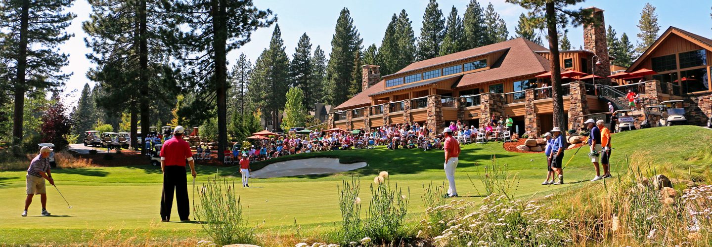 crowd watches golfers during a tournament