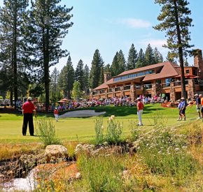 crowd watches golfers during a tournament