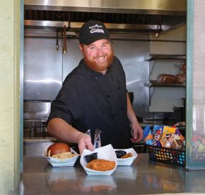 beach employee with food at snack bar