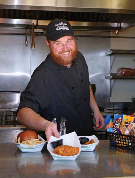 beach employee with food at snack bar