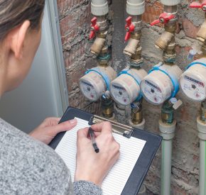 Woman reading the water meter. Household water consumption
