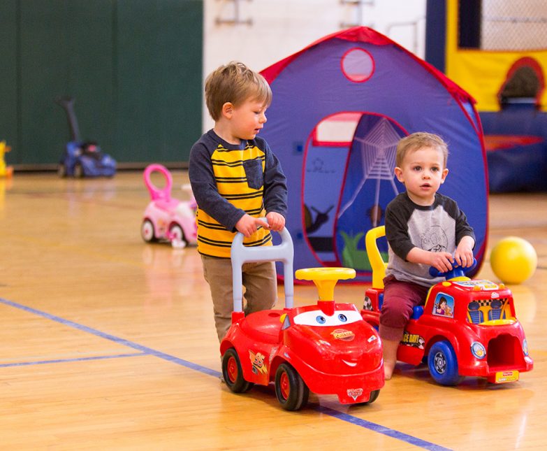 boys push cars
