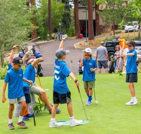 junior golf league players on practice green