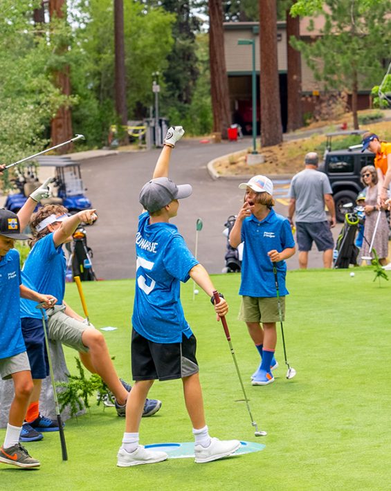 junior golf league players on practice green
