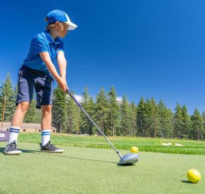 youth golf camp boy at range