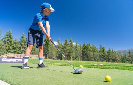 youth golf camp boy at range