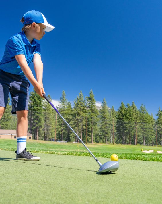 youth golf camp boy at range