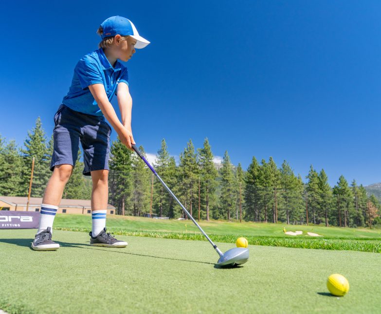 youth golf camp boy at range