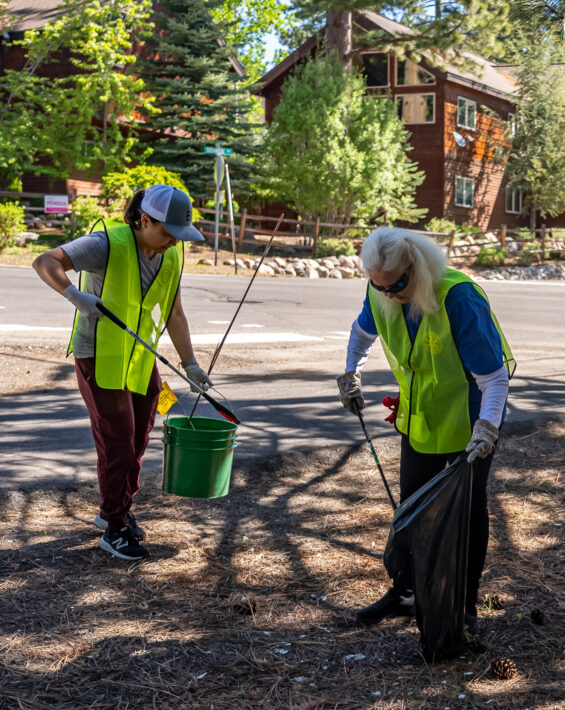 two women picking up trash