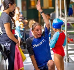 swim lesson male instructor gives instruction on pool deck
