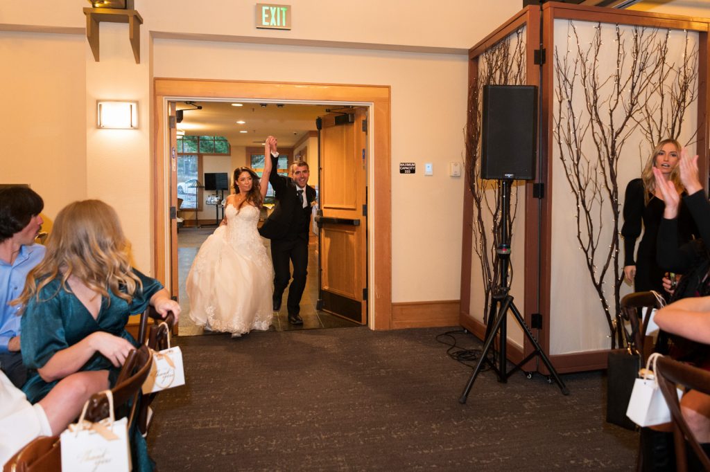 bride and groom holding hands walking into Chateau wedding