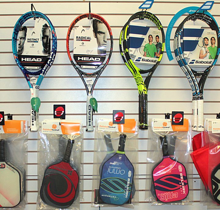 tennis rackets and pickleball paddles in pro shop