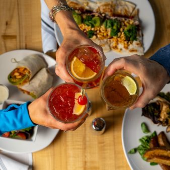 group cheersing drinks from above