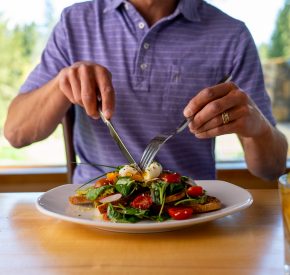 man cuts poached egg at The Grille
