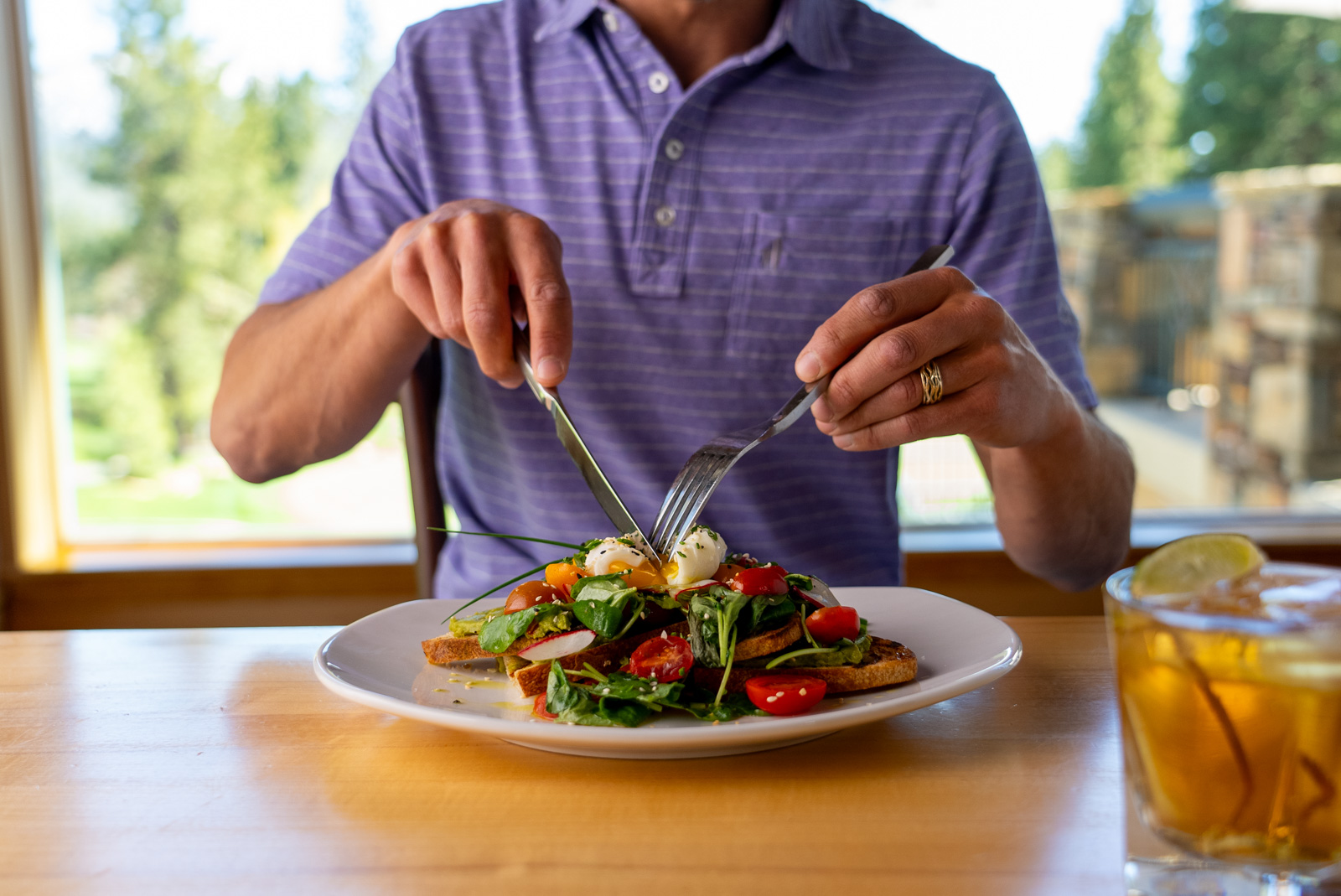 man cuts poached egg at The Grille