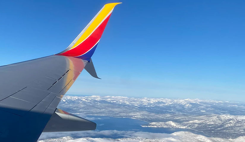 airplane wing with lake tahoe in distance