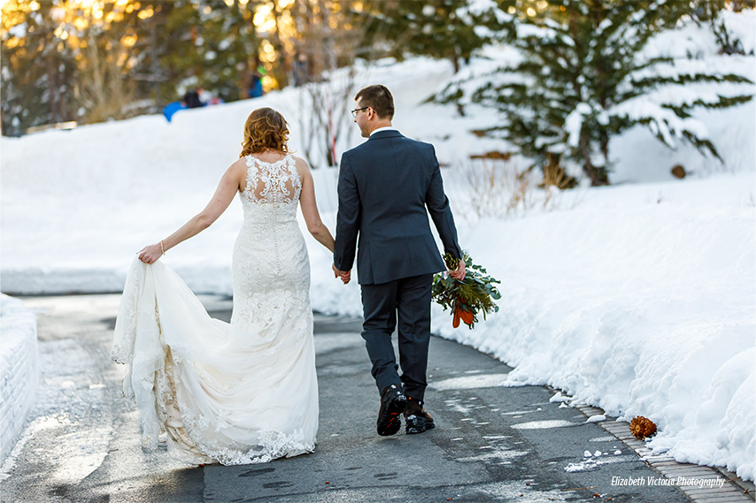 winter wedding couple holds hands