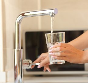 Tap water pouring into a glass