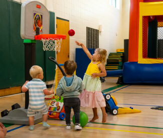 kids playing basketball at preschool playground