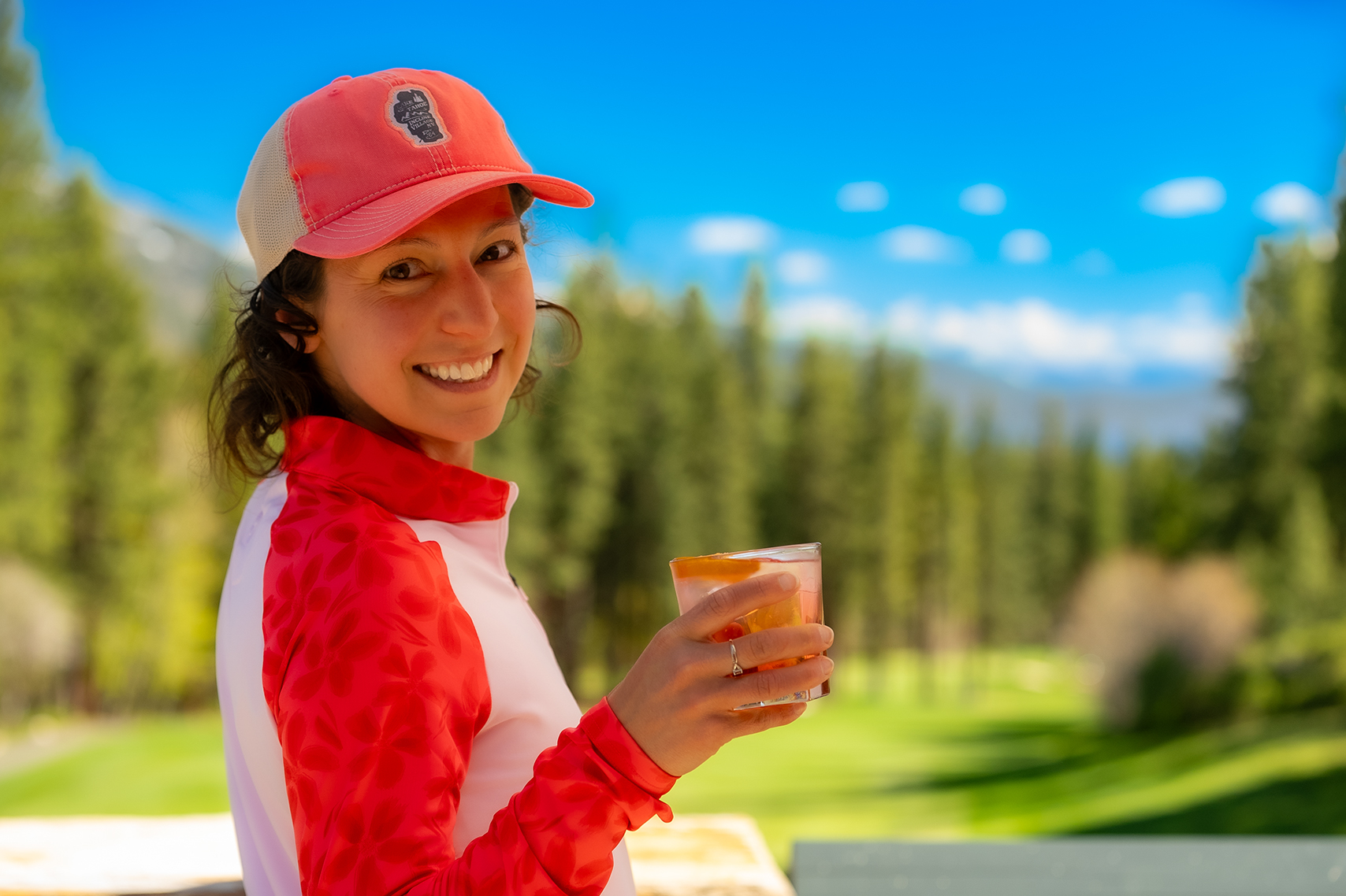 woman holding cocktail on the grille deck