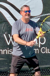 john klein holding tennis racket