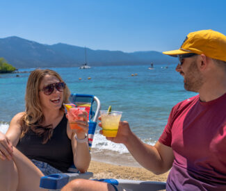 couple with cocktails on the beach