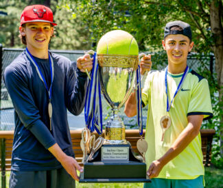 young men with tennis tournament trophy