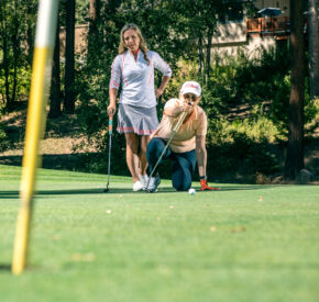 putting lesson with two female golfers