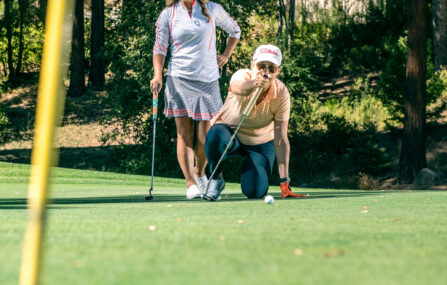 putting lesson with two female golfers