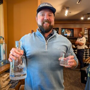 golf shop merchandise staff dads and grads pick chris holds a decanter and tumbler glass