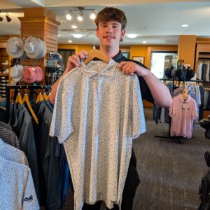 golf shop merchandise staff dads and grads pick zach holds up polo