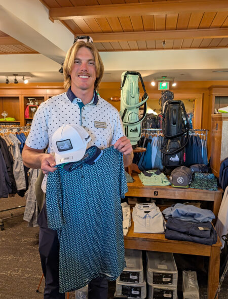 golf shop merchandise staff dads and grads pick dalton holds up hat and polo