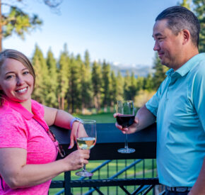 couple with wine glasses on the deck at The Grille