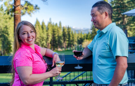 couple with wine glasses on the deck at The Grille