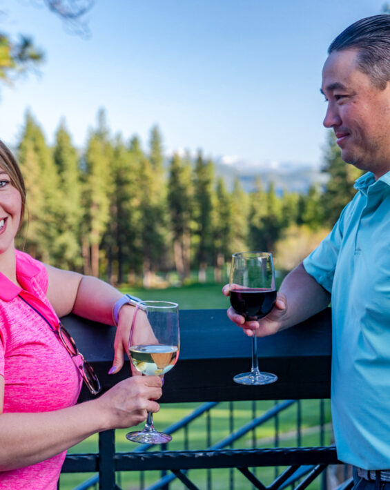 couple with wine glasses on the deck at The Grille