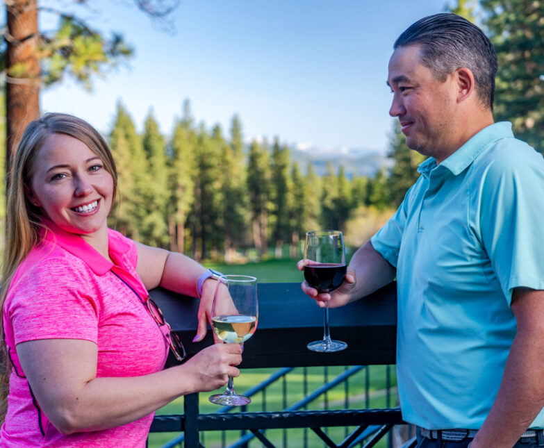 couple with wine glasses on the deck at The Grille