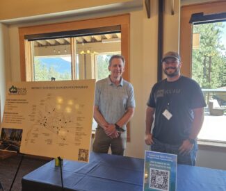 managers at community open house at Chateau