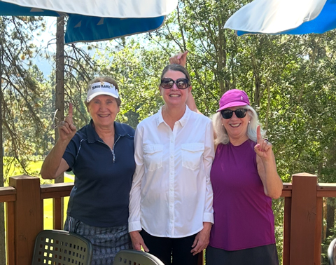 ladies pose on mountain course deck