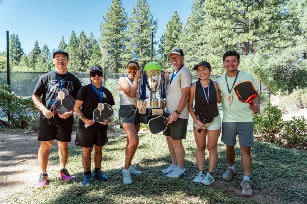 pickleball tournament players with trophy