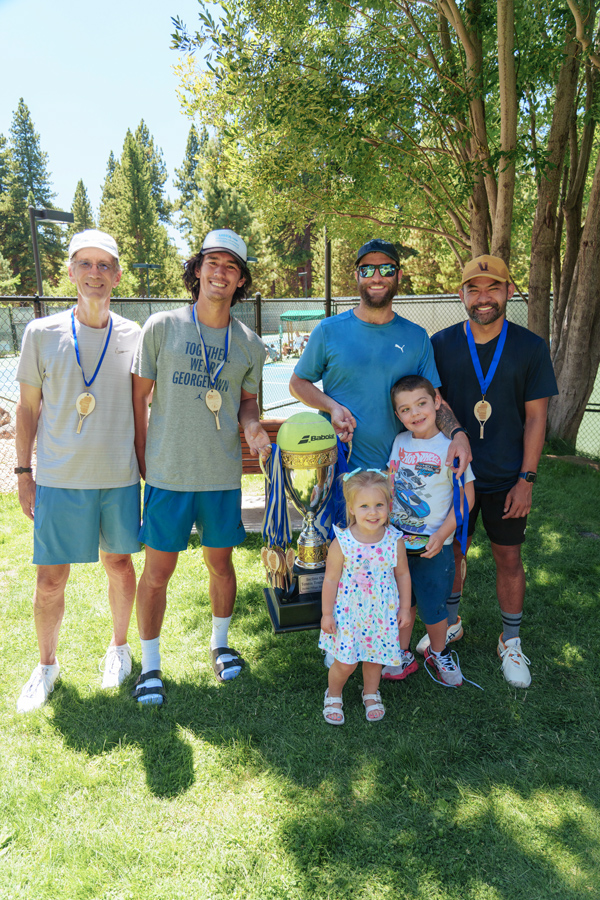 tennis tournament winners with trophy