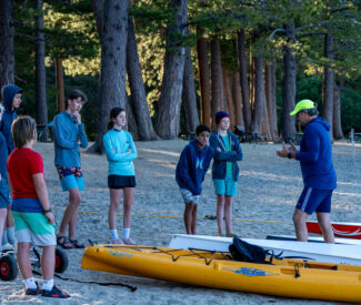 youth rowing camp group with coach