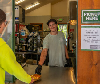 snack bar staff hands food over