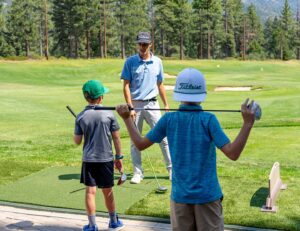Carson Kristich teaching a youth golf lesson
