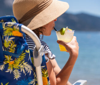lady with cocktails on beach